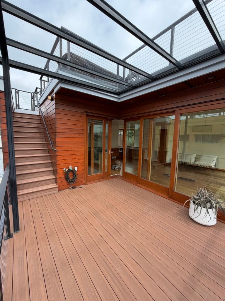 Home With Top To Bottom Windows and Glass Above