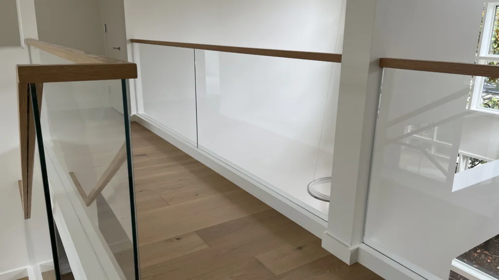 glass railing with wood topper in washington home