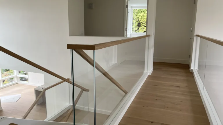 clear glass railing with wood on top in luxury washington home
